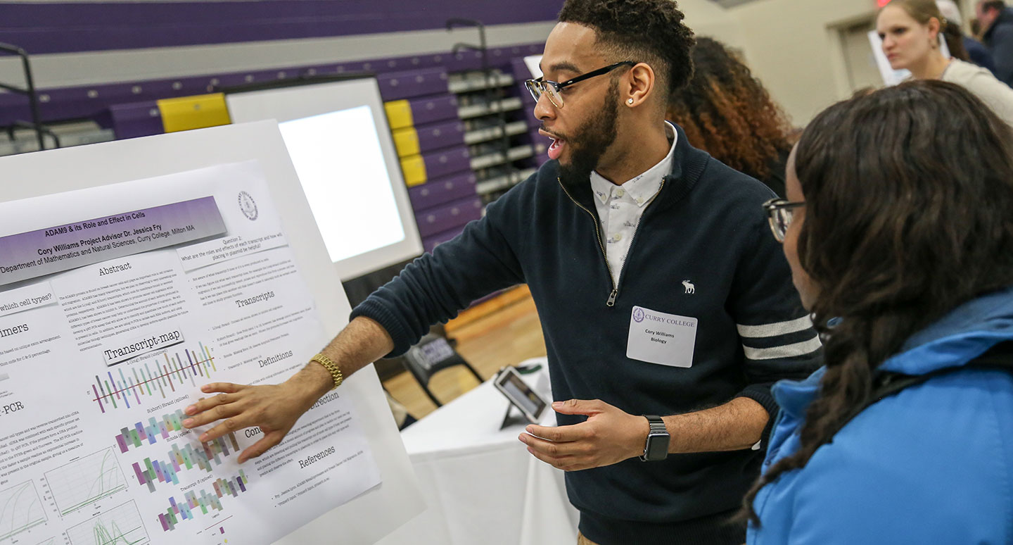 A student presents his research at the Curry College Annual Academic Forum