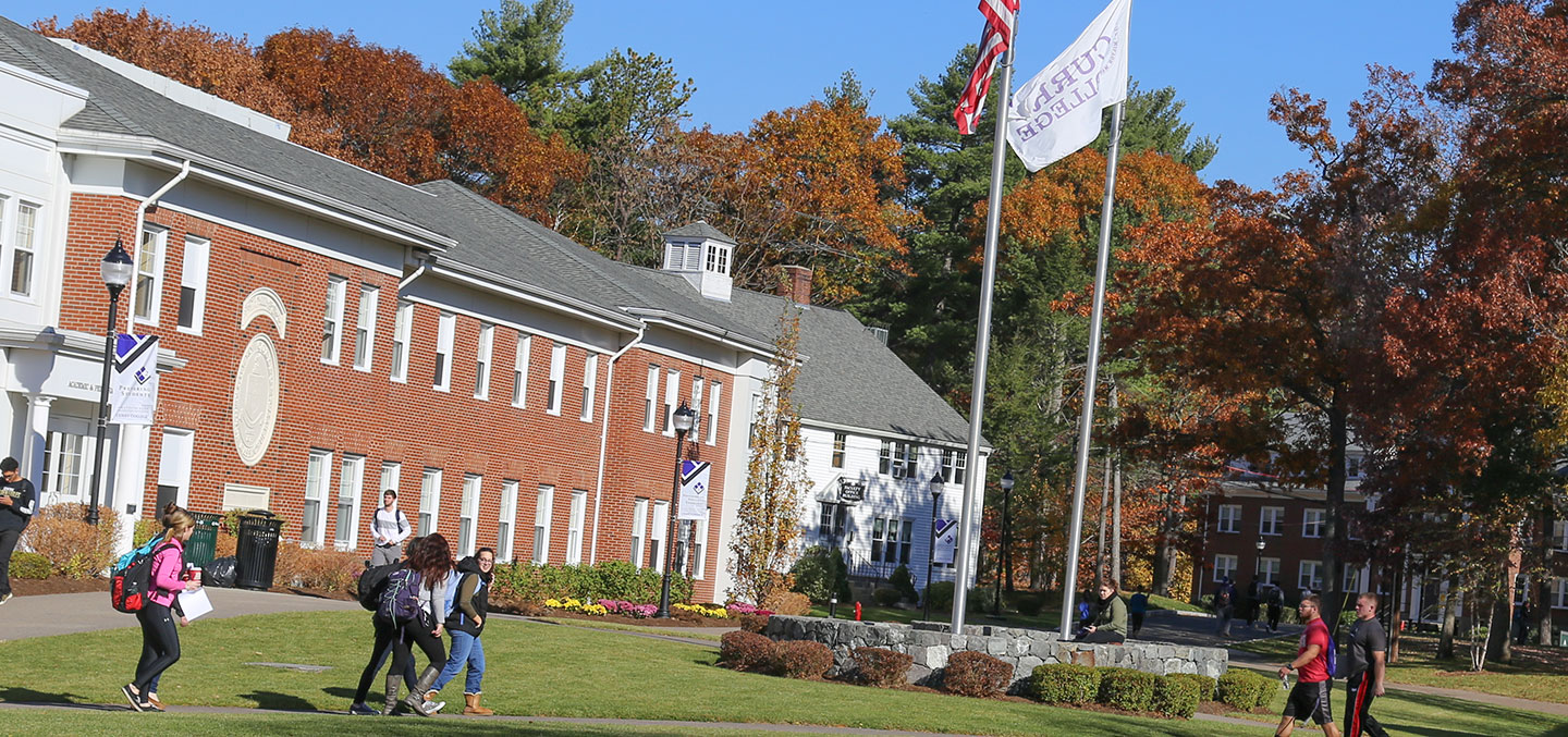 Scenic of the Curry College Milton Campus Quad with students walking to class
