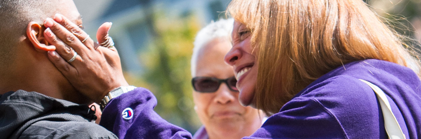 A First-Year parent hugs her son on the first day of Curry College
