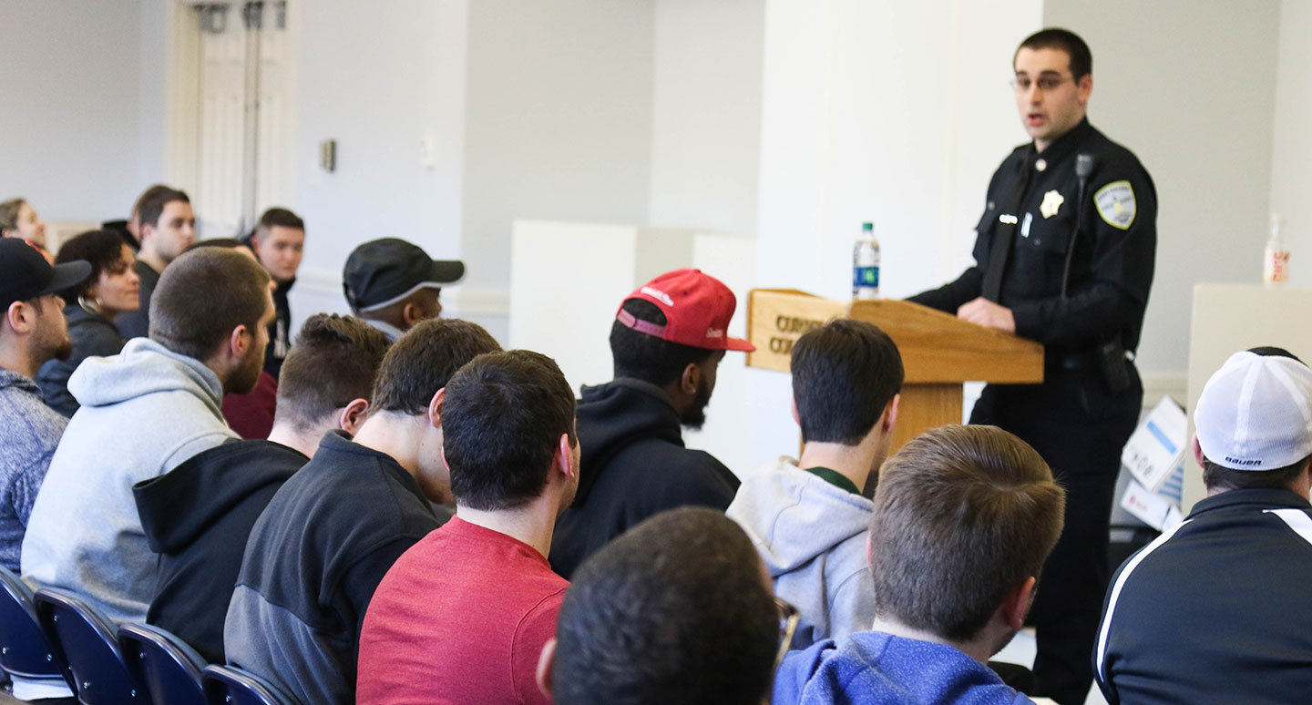 An officer speaks to criminal justice students