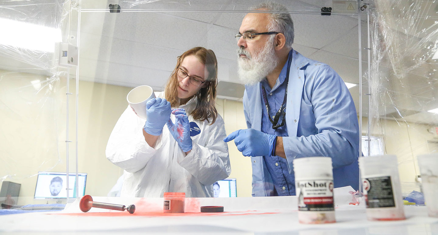 A student and faculty member Collaborate in the Curry College Forensic Science Lab
