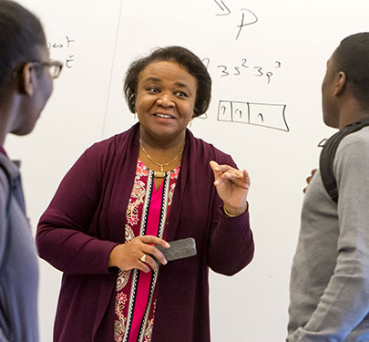 A Curry College faculty member interacts with students in the classroom