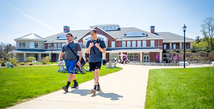Curry College student walks to class with a friend