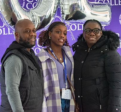 A student poses with her family at Accepted Student Day