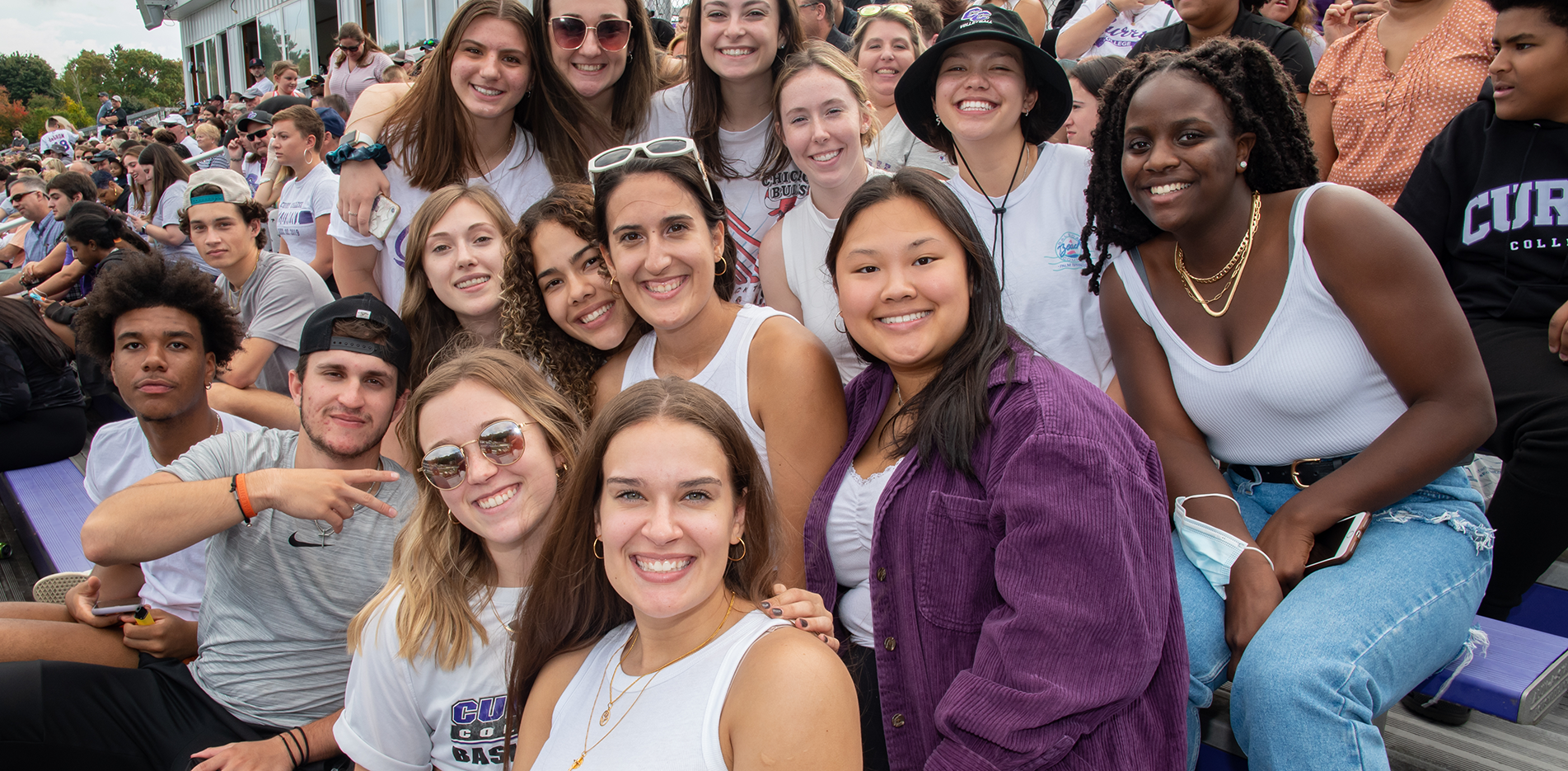 Curry College Alumni pose for a photo at Homecoming