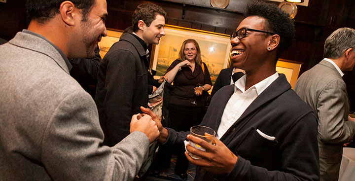 Curry Colege Alumni shake hands at an alumni networking event in New York City