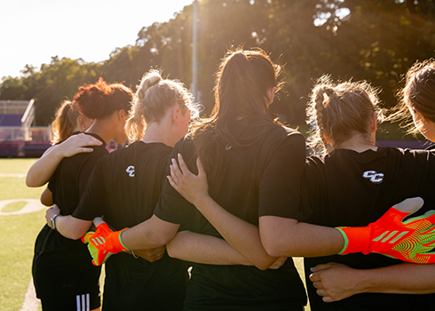 Curry Women's Soccer Team in a huddle