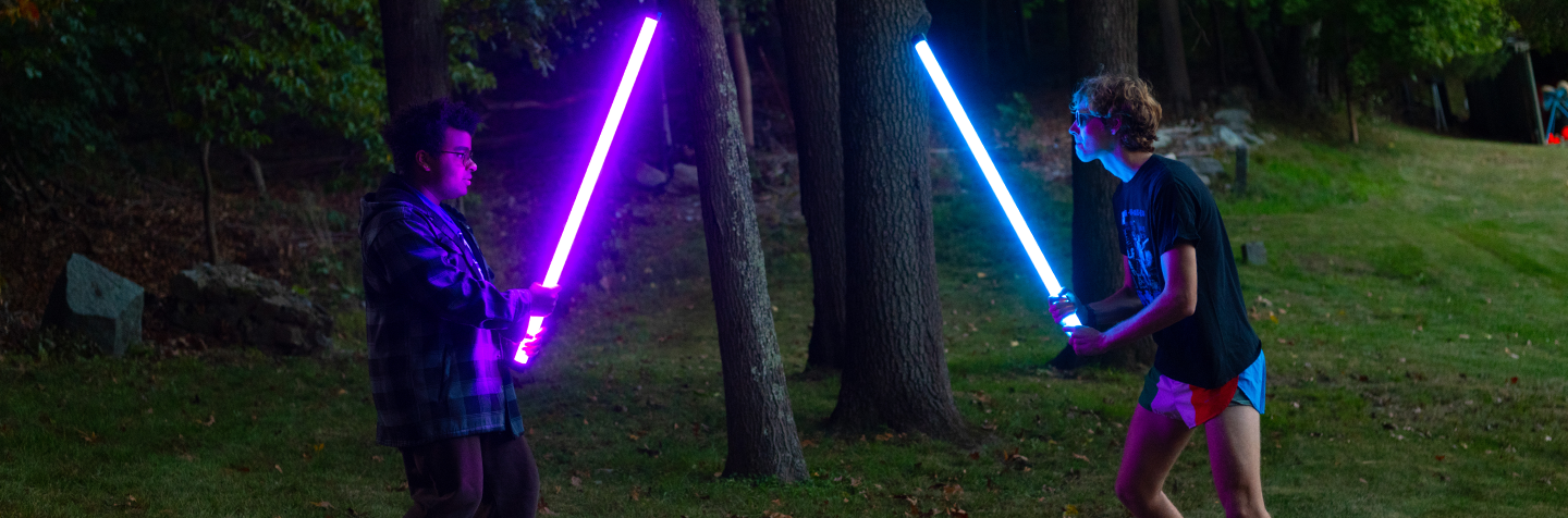 Nerd Empire members engage in a lightsaber duel