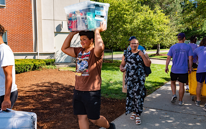 A new student moves in to the Curry College residence halls
