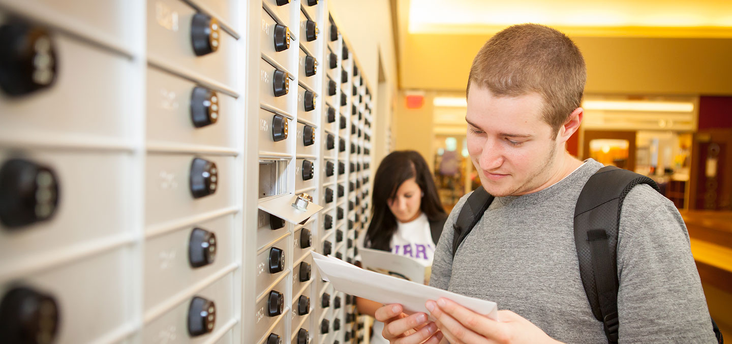 A student gets his mail at the Student Center