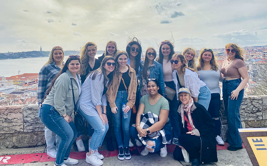 Students pose with Lisbon, Portugal city in the background