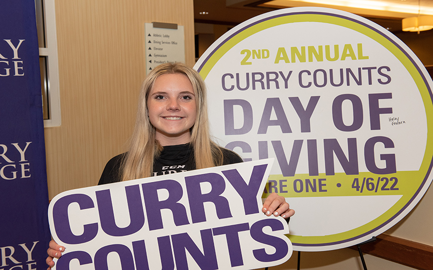 Curry student holds Curry Counts sign