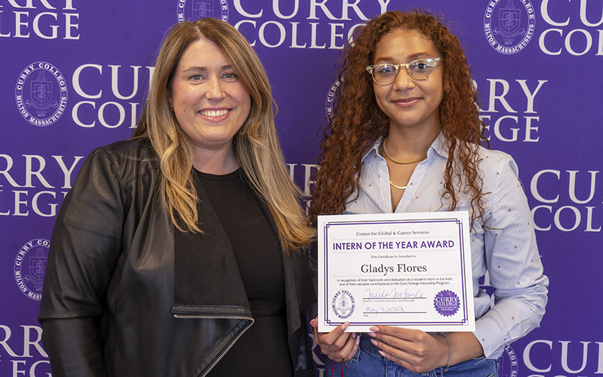 Gladys Flores '22 Poses with Intern of the Year Award