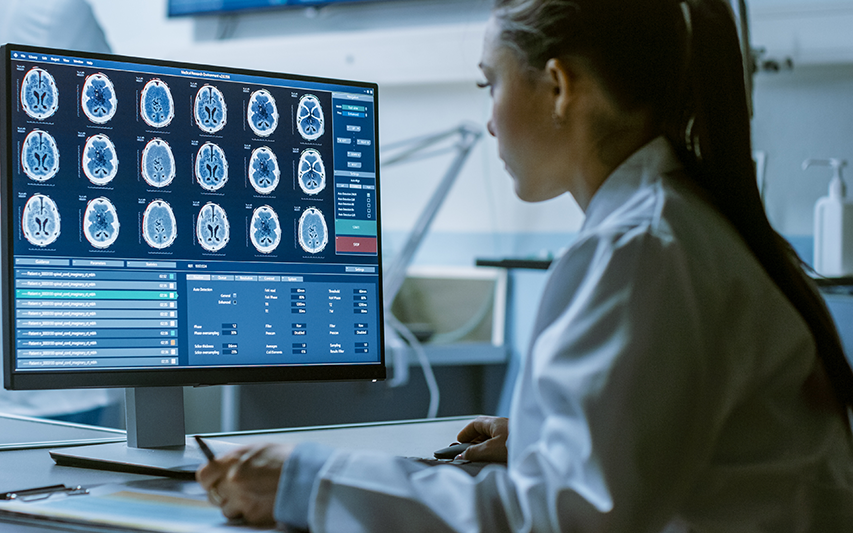 Student studies brain activity on computer screen