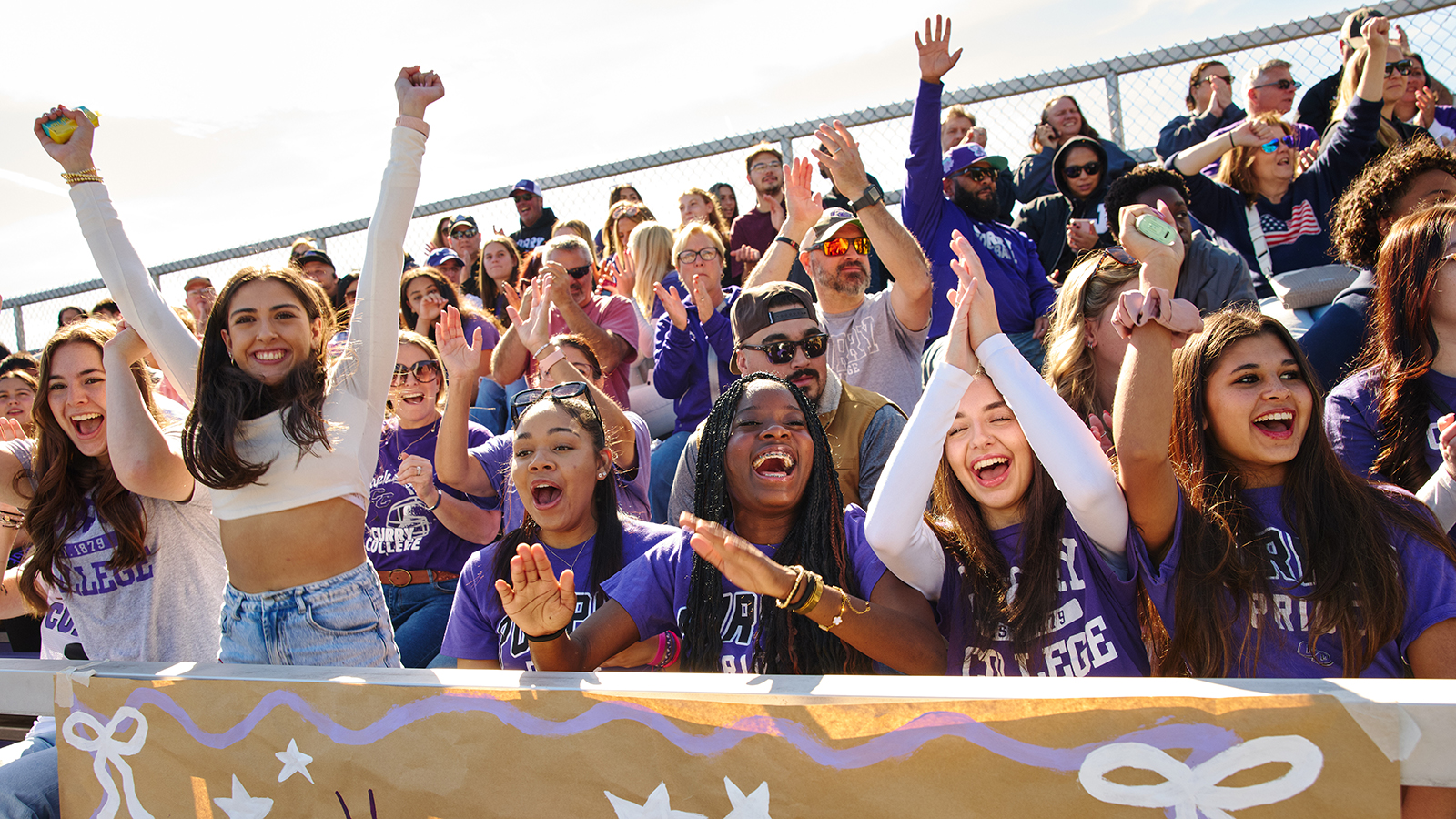 Students cheer in football stands