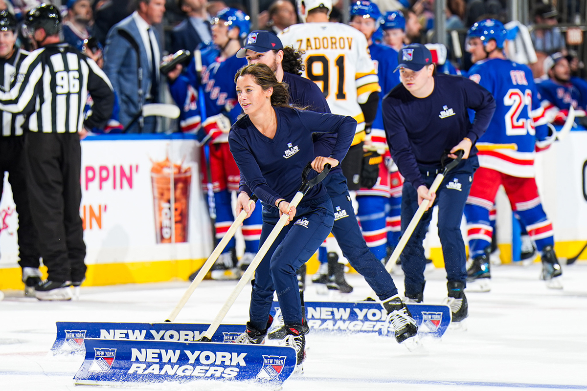 Danielle Reid skates on the ice as blue crew member
