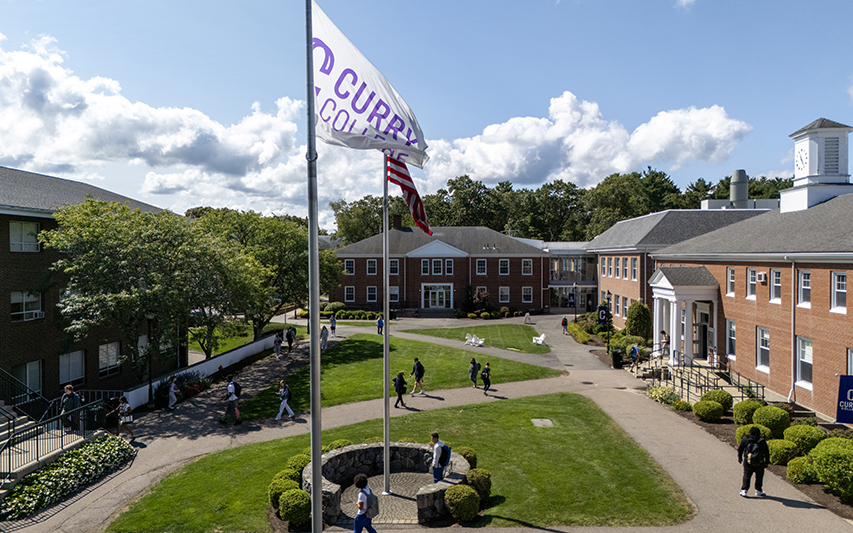 Drone shot of the academic quad with students passing by