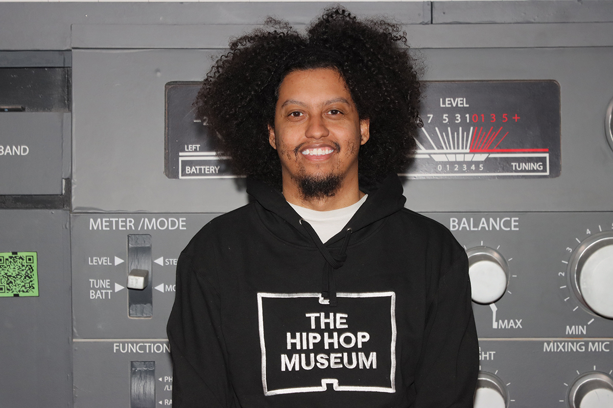 Kylerr smiles with Hip Hop Museum sweatshirt