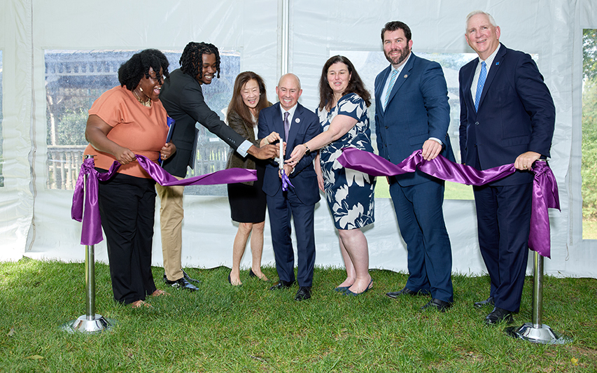 Curry and Labouré leadership cut a purple ribbon