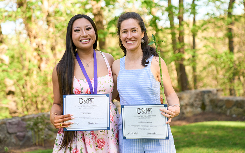 An AGB recipient and her mentor pose for a photo on the Curry College campus