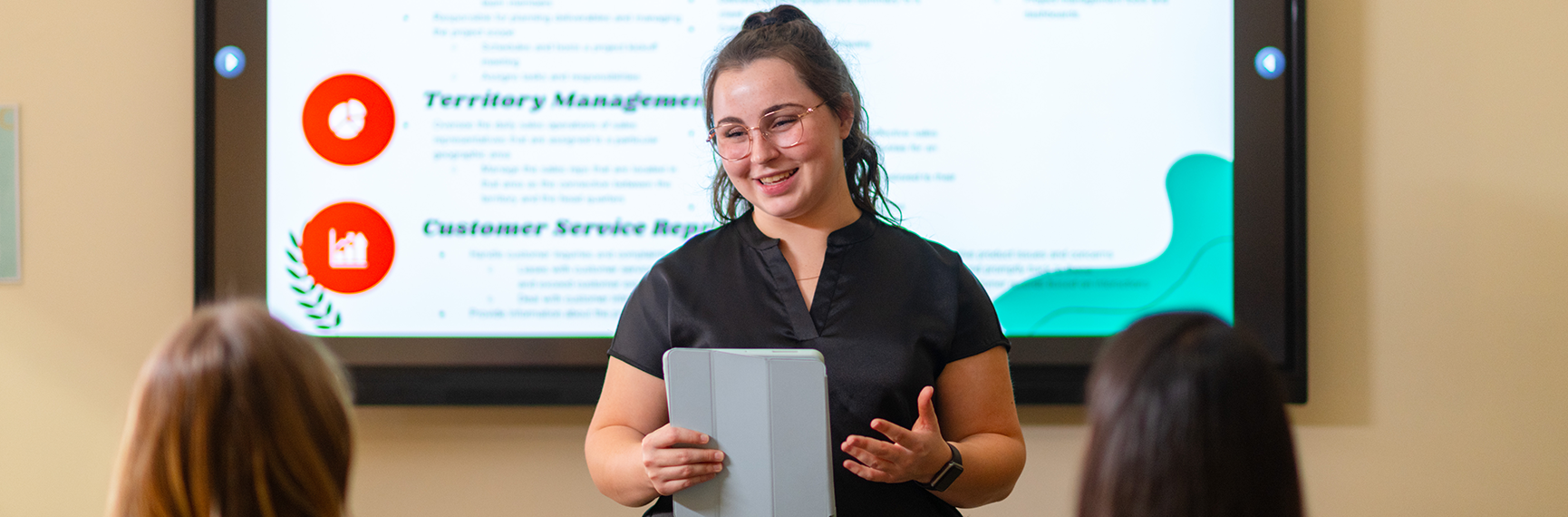 A student gives a business presentation at Curry College