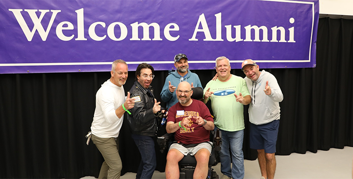 Alumni pose for a pic at the Loose Caboose Pub Revival