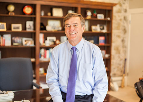 Kenneth K. Quigley, Jr., the 14th President of Curry College, is pictured in his office.