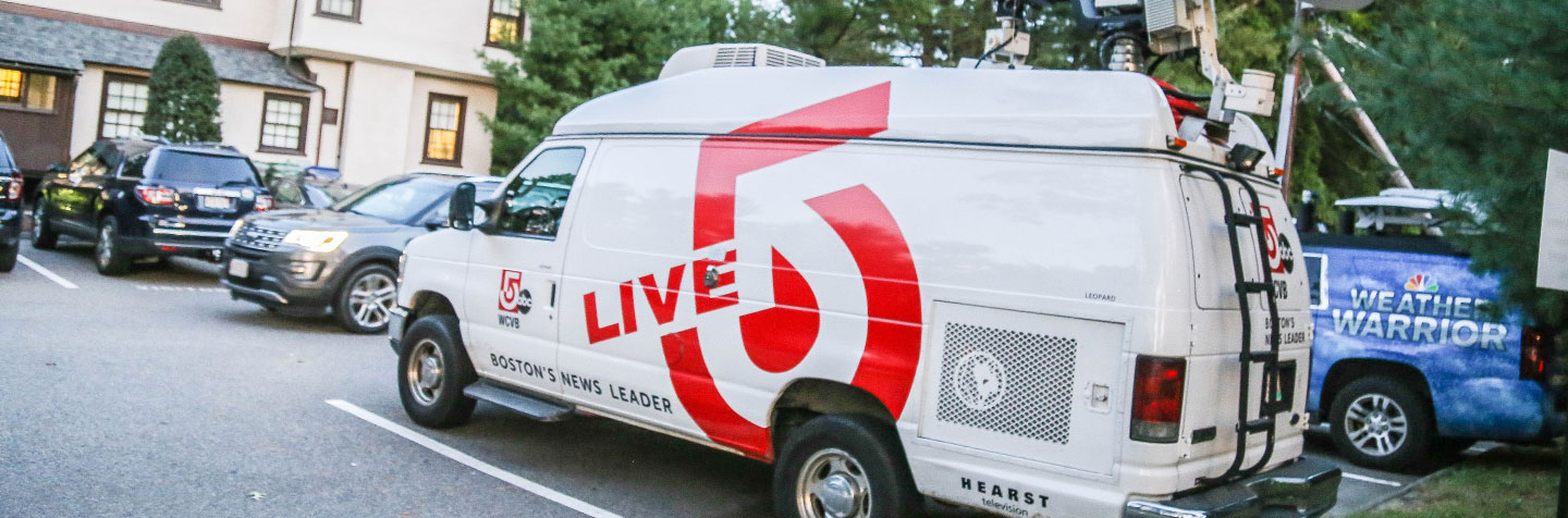 News media vehicles in Curry College Keith Alumni House parking lot