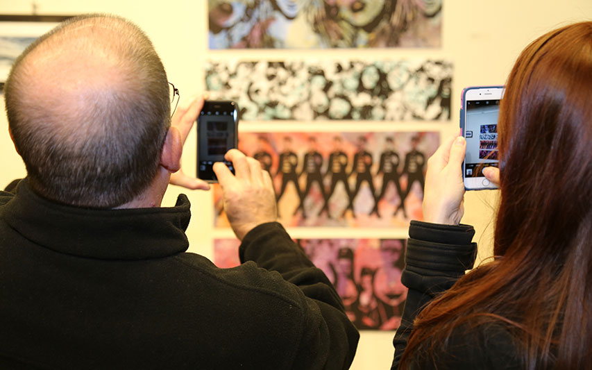 People take cell phone photos of artwork