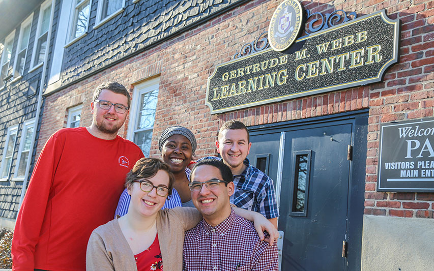 PAl students pose outside the Curry College Gertrude M. Webb Learning Center. 