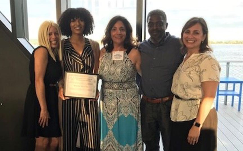 Ana Dawkins, Briana Dawkins '18, Colin Dawkins, NEACJS president Michele Bratina, and Criminal Justice and Sociology Professor Jennifer Balboni, celebrate after the award ceremony.