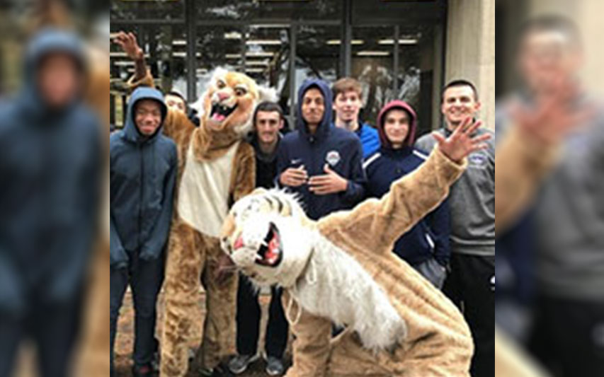 Men's Basketball student-athletes pose with mascot