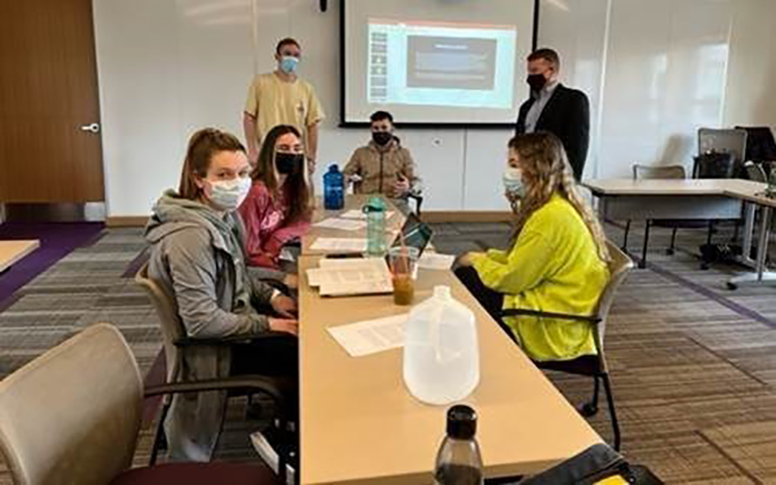 Students sitting at a table for bystander course