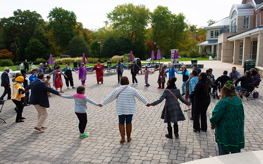Curry College community participates in a circle dance during Indigenous Peoples' Day Celebration