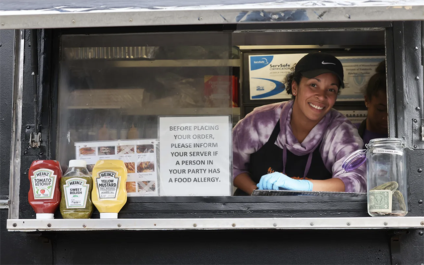 Justine Ramos '05 Serves Food out of Food Truck "Cheesy Chicks" (Photo Credit Marc Vasconcellos/The Enterprise)