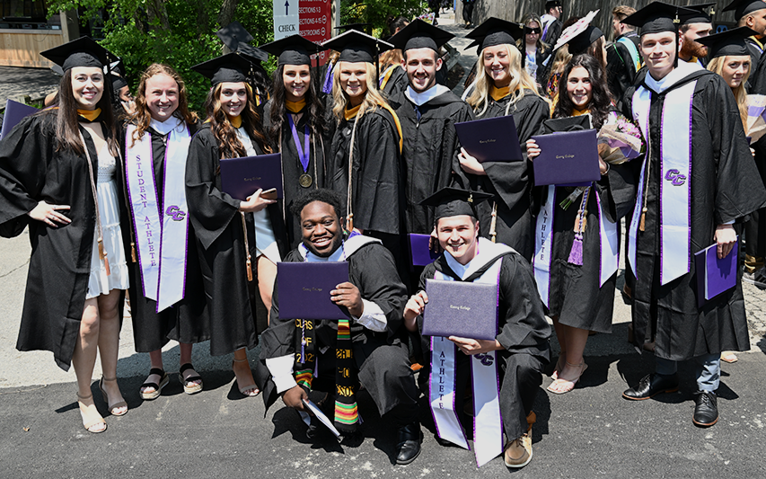 Graduates pose for a pic at the 2023 Curry College Commencement