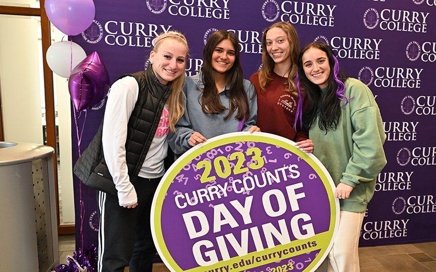students pose at annual Day of Giving event