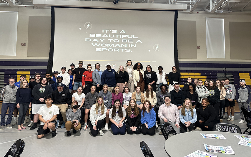 Women in Sports panel pose with students 