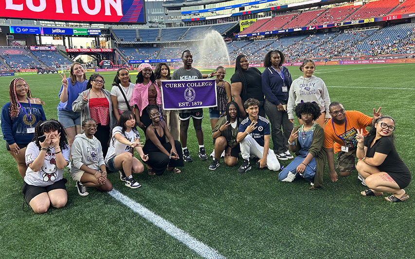 MAP Program Participants Pose at Revolution Game with Curry Flag