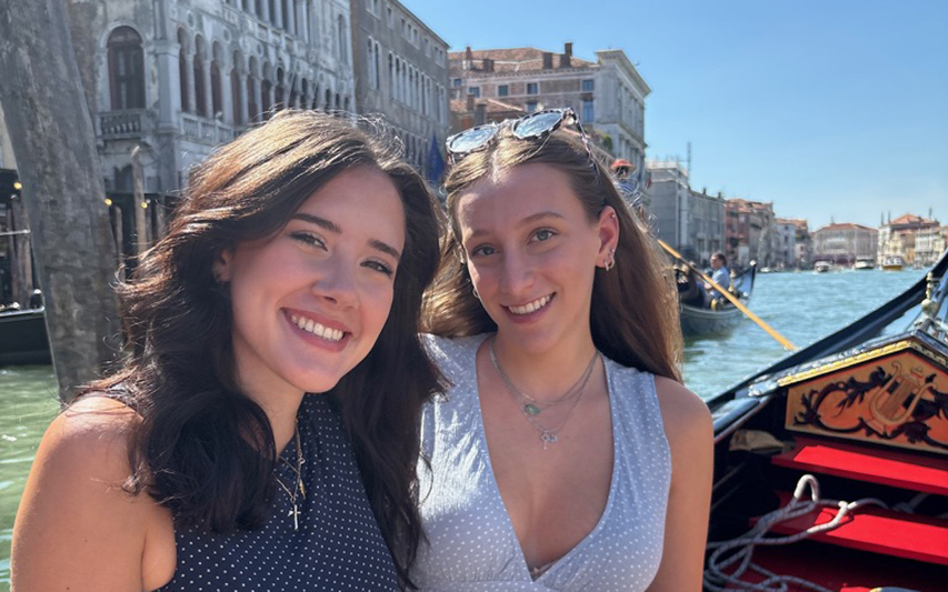 Ella Hayward poses with classmate on a boat in italy