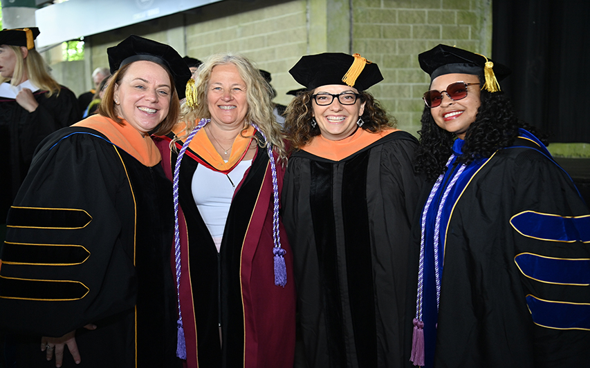 Curry professors pose in regalia at commencement 
