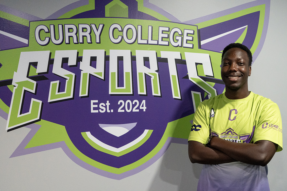 Marvin poses next to Esports logo