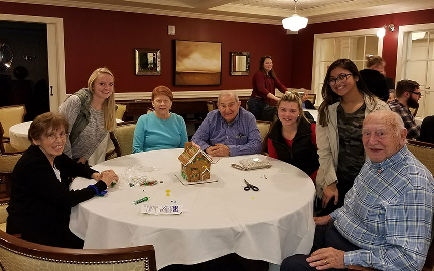 School of Nursung student make gingerbread houses with senior residents