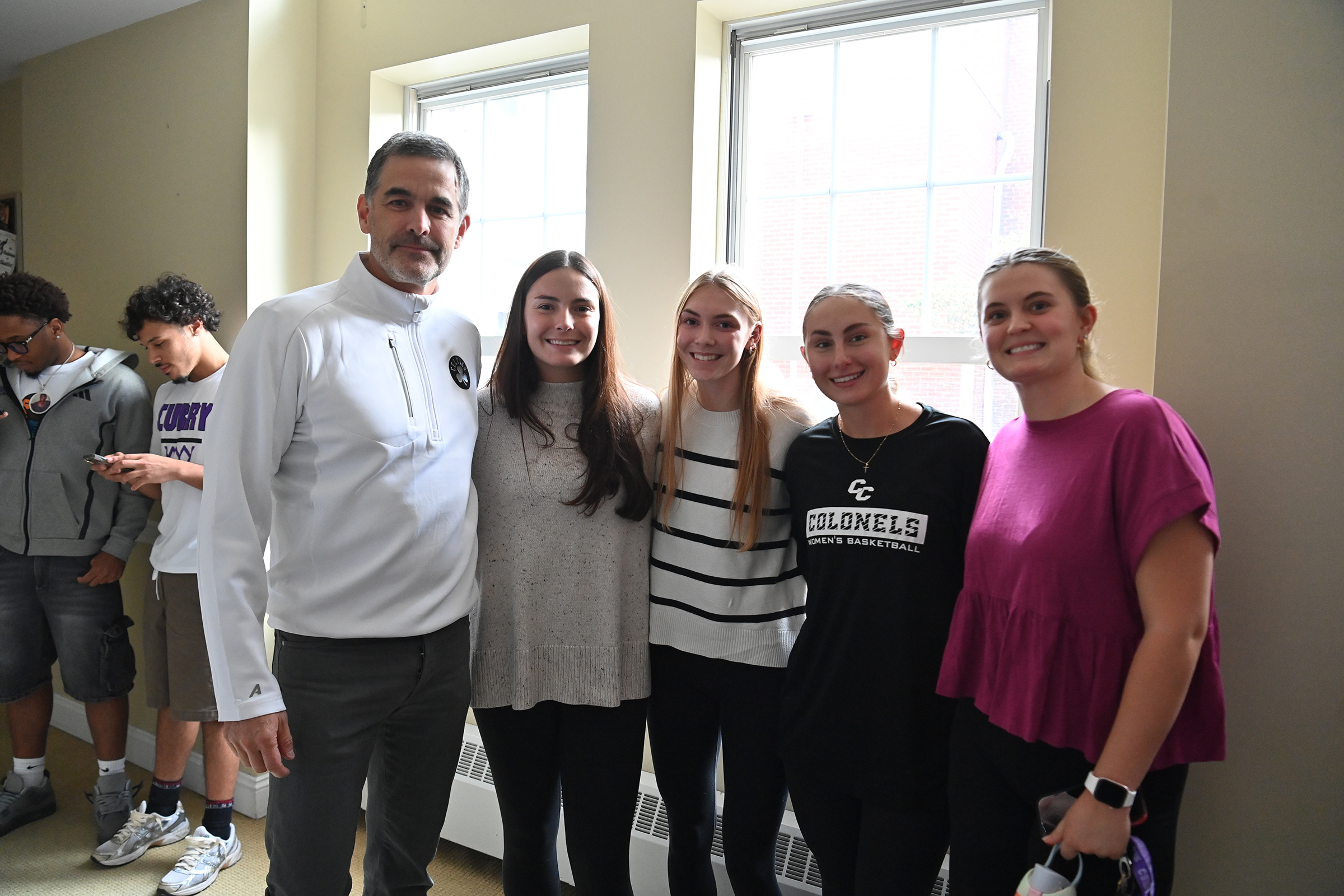 Bill Chisholm poses with students