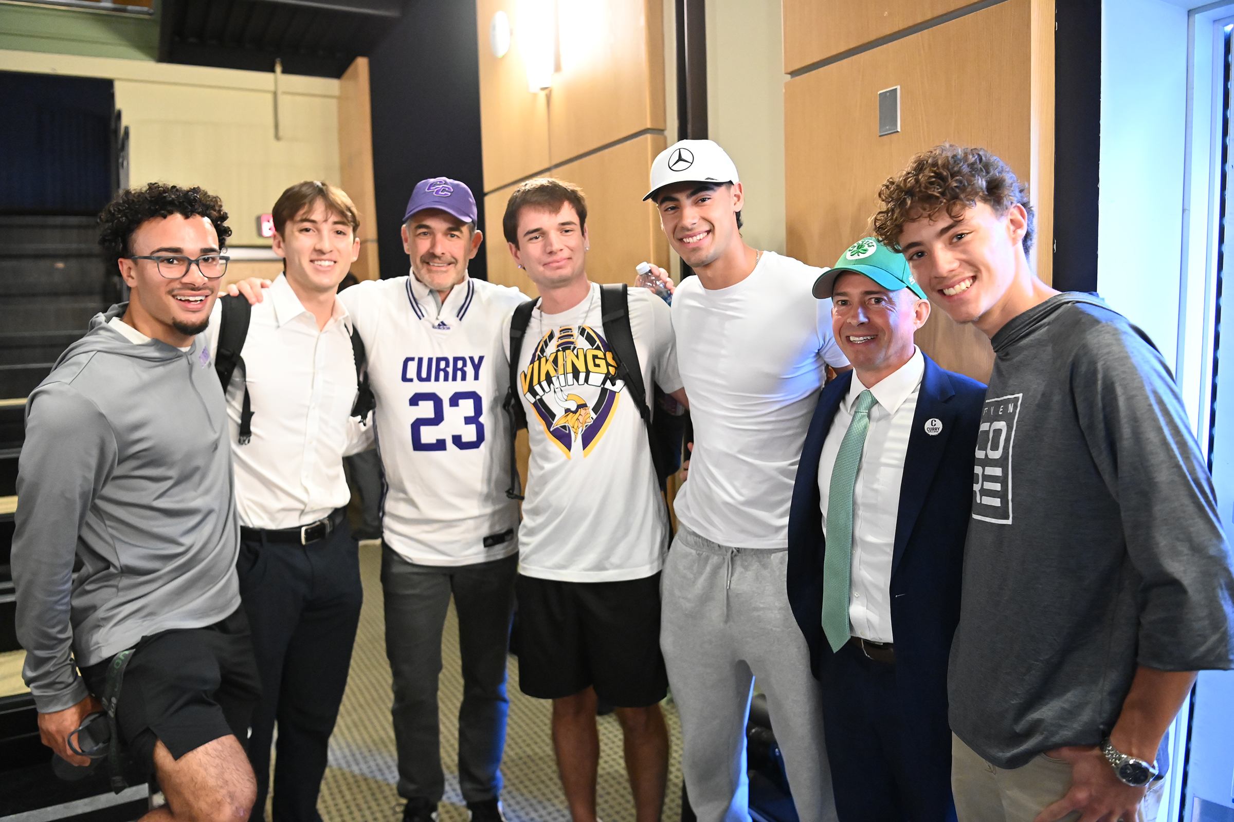 Bill Chisholm poses with students