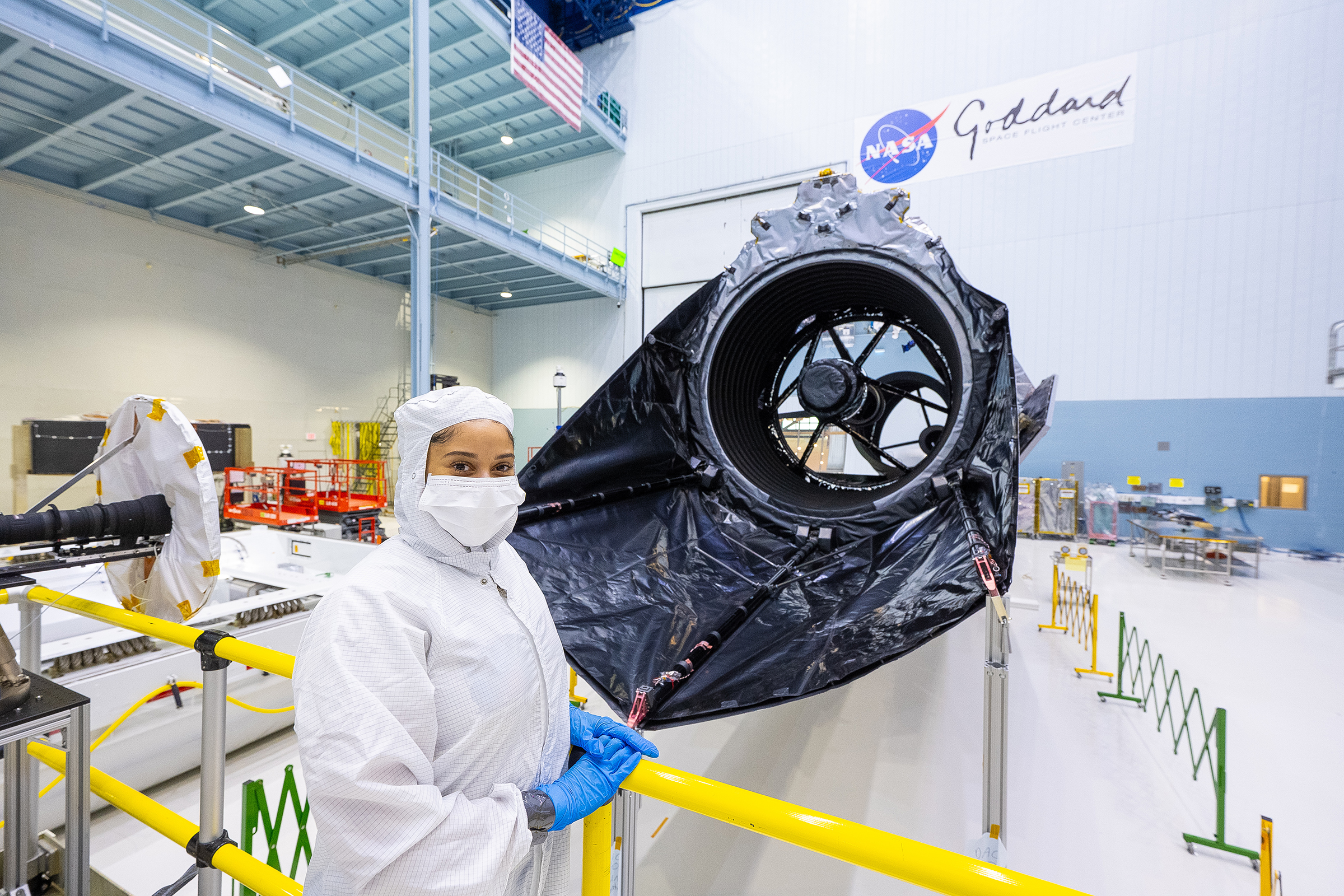 Courtney Lee poses in the clean room at NASA