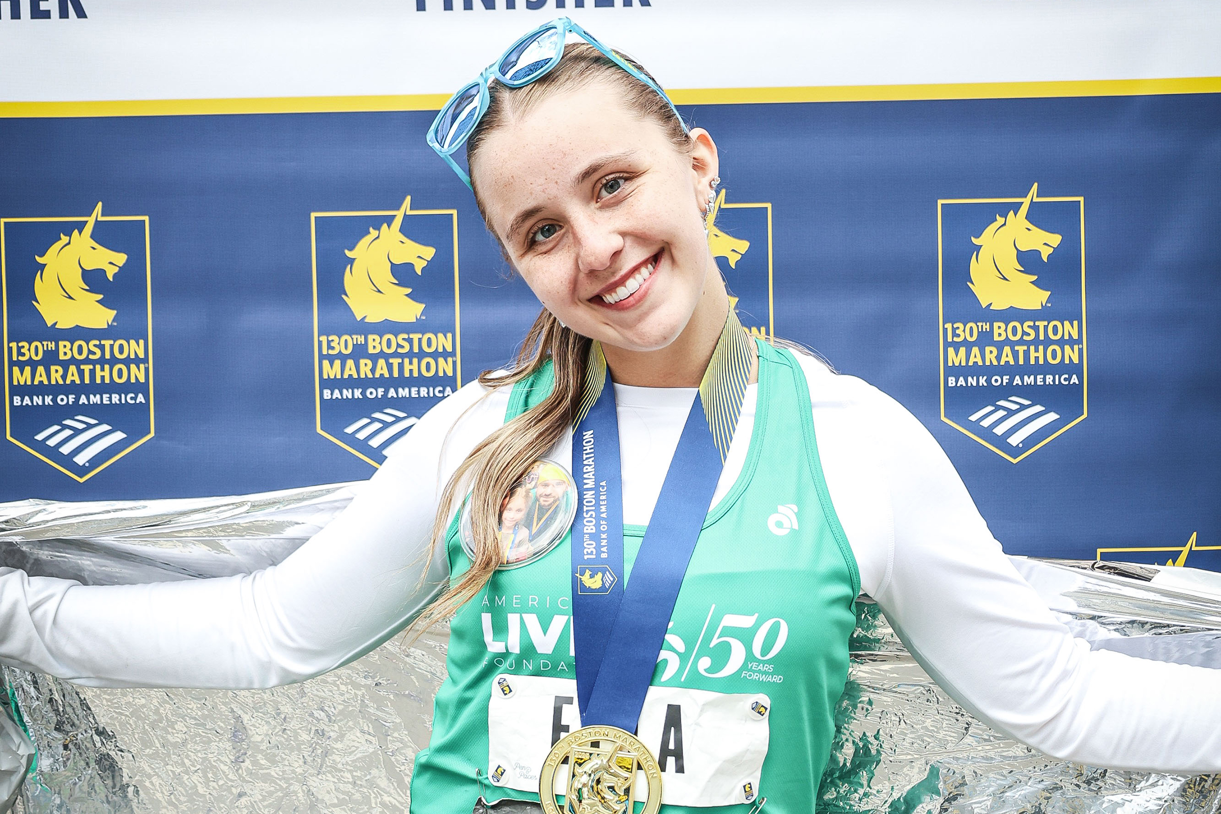 Ella poses with boston marathon medal