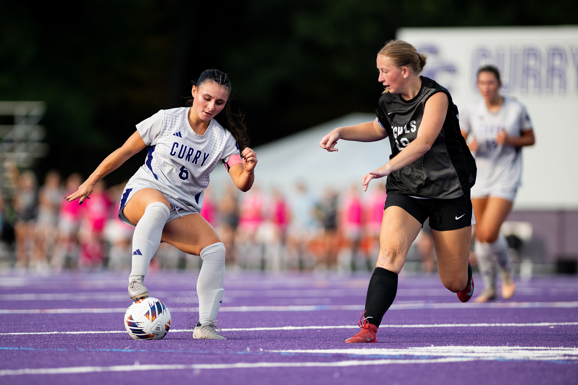 Mia Schena takes on a defender