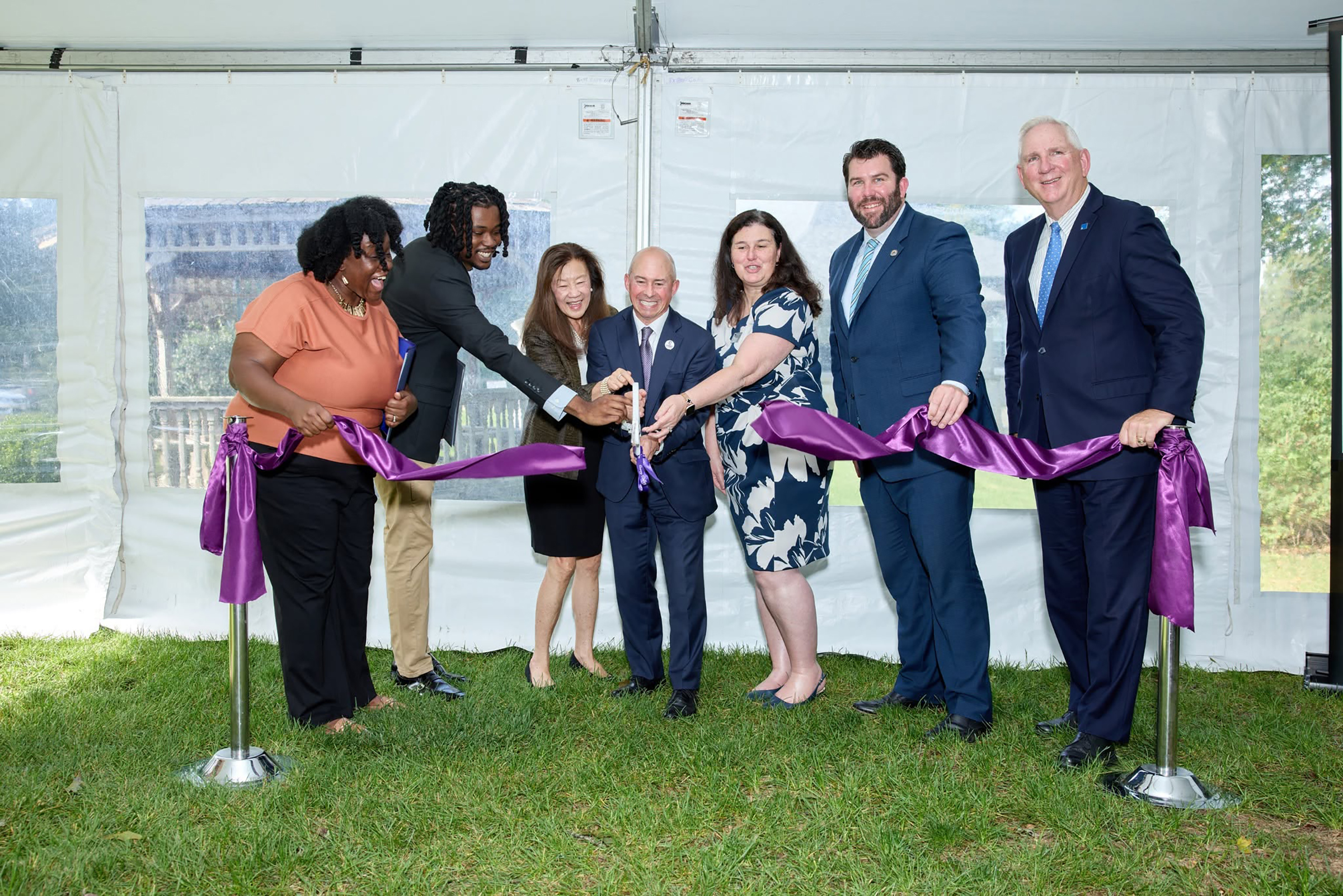 Leadership cuts a purple ribbon at Laboure Ribbon Cutting event 