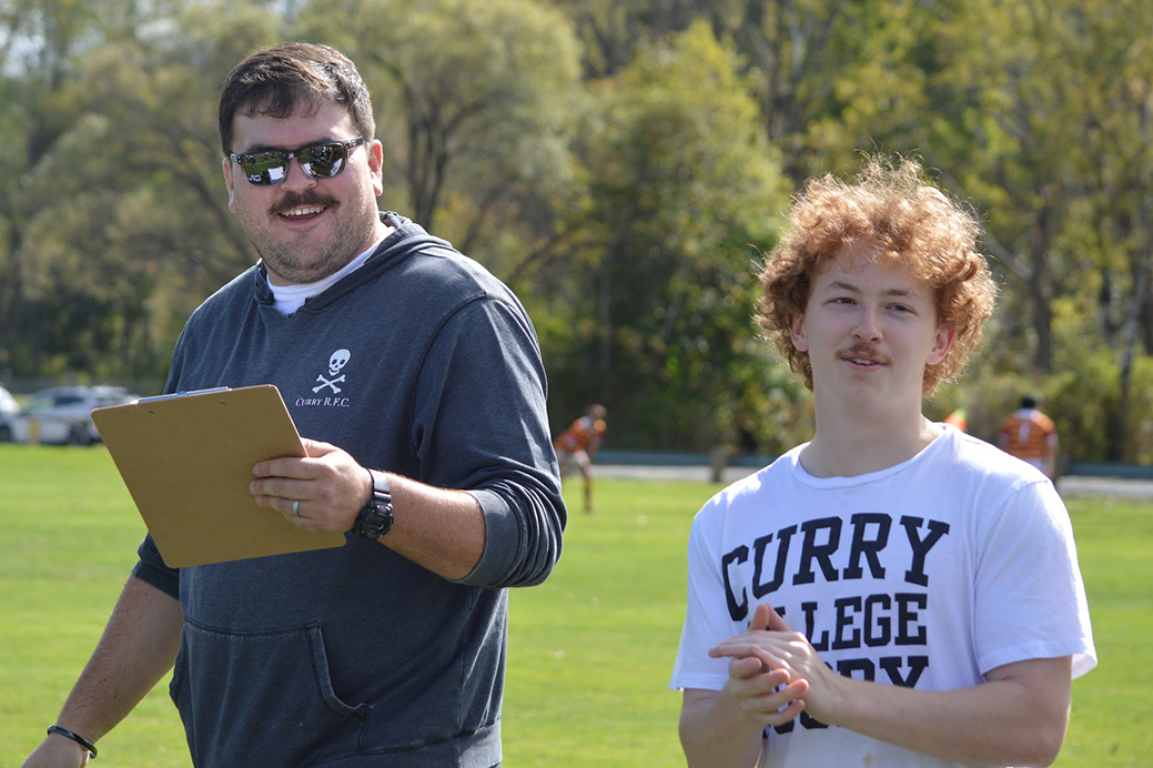 Head Coach Ben Tourruella coaches on the sideline alongside player Conor Worthing